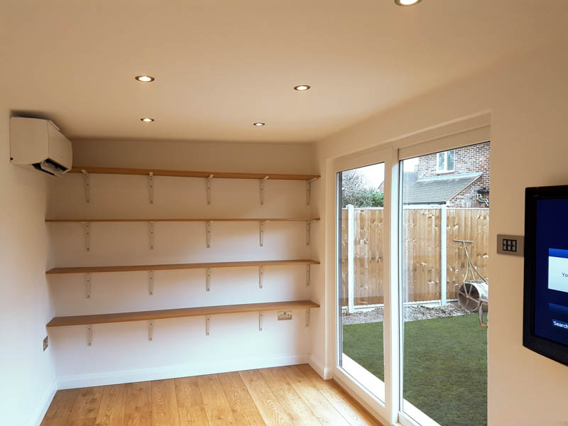 Air con, Sky TV and custom shelves were incorporated into the garden office
