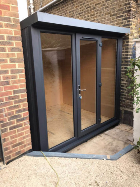 The 2.4m office just fits beside the house